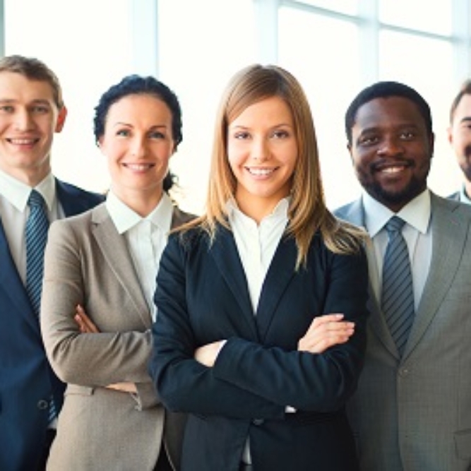 Group of business partners looking at camera with smiles, pretty leader in front